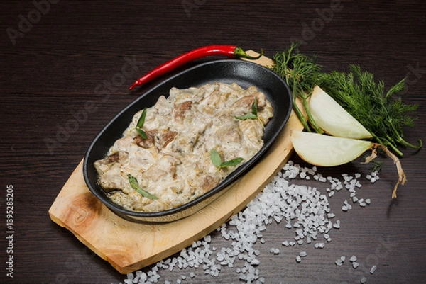 Fototapeta Meat in a creamy sauce with mushrooms and cheese