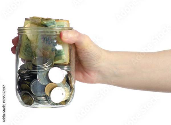 Fototapeta Glass jar of gold coins and paper money in hand