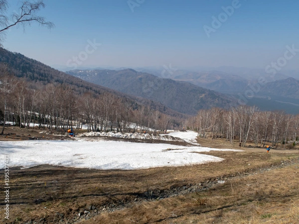 Obraz Melting snow on a ski slope in the spring in the Altai Mountains