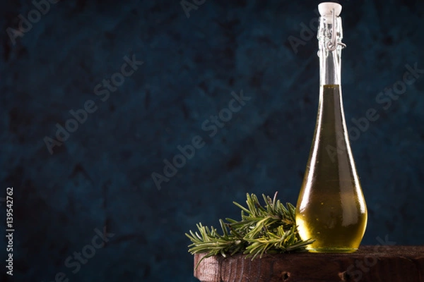 Fototapeta Bottles with different kinds of vegetable oil on table