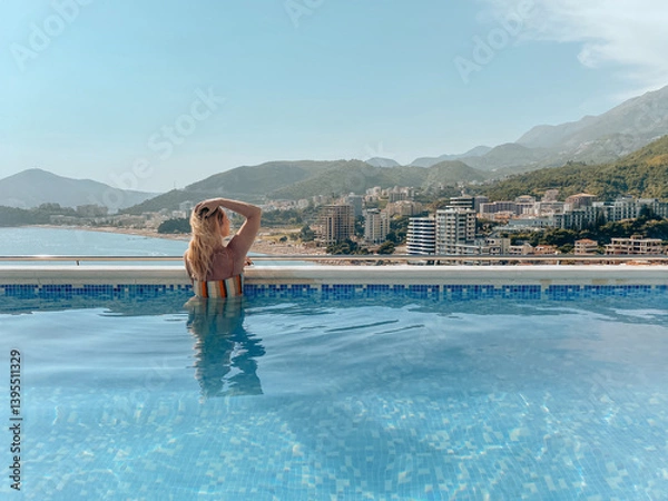 Obraz Woman relaxing in a rooftop pool