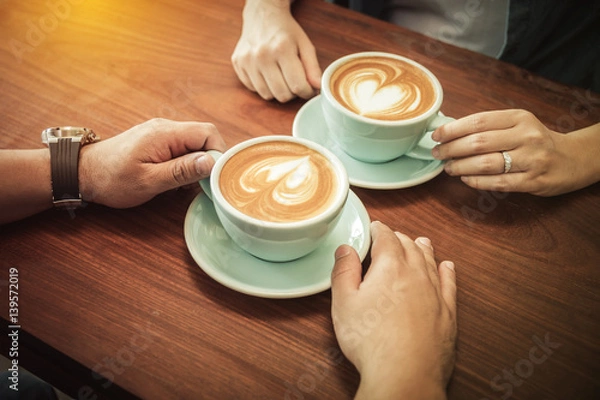 Obraz A couple drinking coffee at cafe together