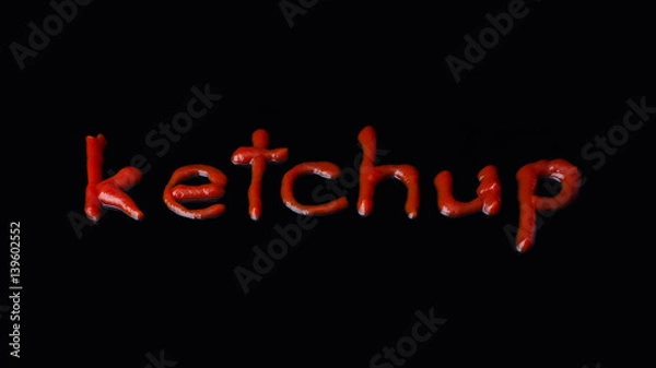 Fototapeta The word ketchup written with ketchup on the black background
