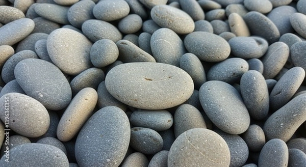 Fototapeta Smooth gray stones create a calming and natural pebble background texture