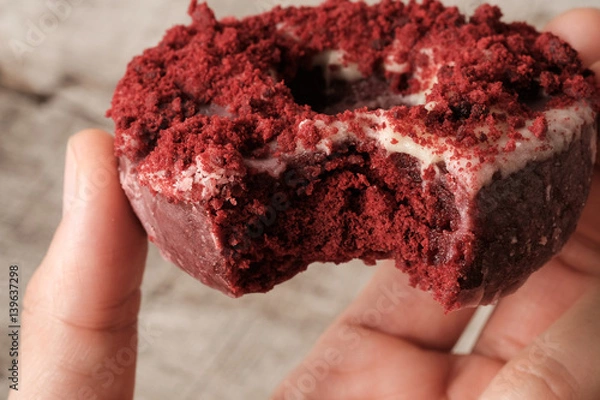 Obraz Close up bite missing red velvet donut