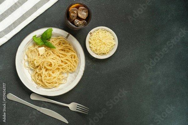 Fototapeta Flatlay of pasta with basil and parmesan on black background.