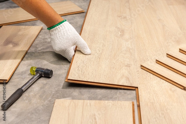 Fototapeta Worker Installing Interlocking laminate floor, home renovation.