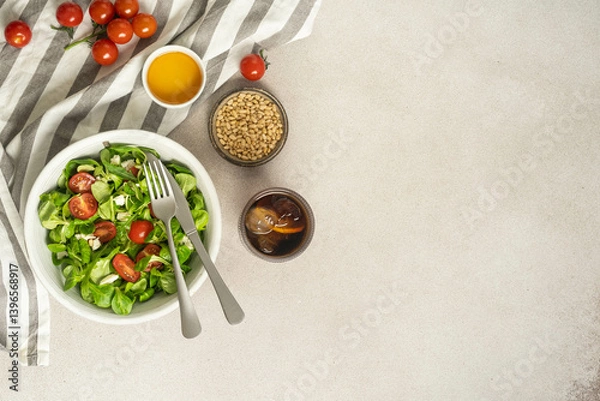 Fototapeta Tomato and mozzarella salad with pine nuts and fork.