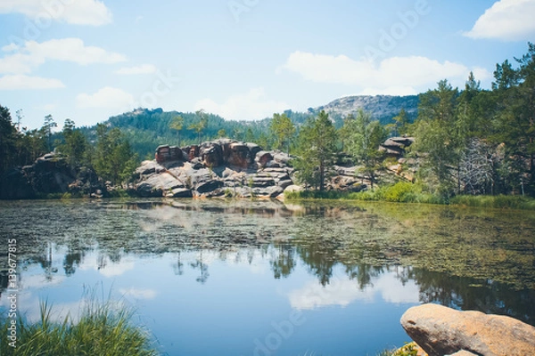Fototapeta Mountain lake in the background of mountains and sky