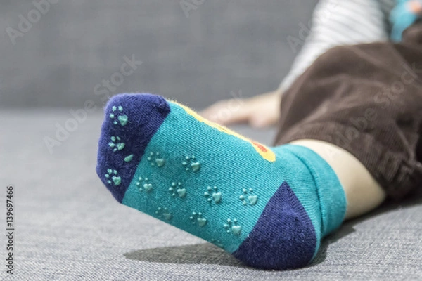 Fototapeta Non-slip socks worn by the child