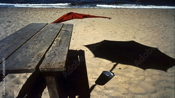Obraz A chilled coconut drink resting on a wooden beachside table, with a sun umbrella casting a soft shadow