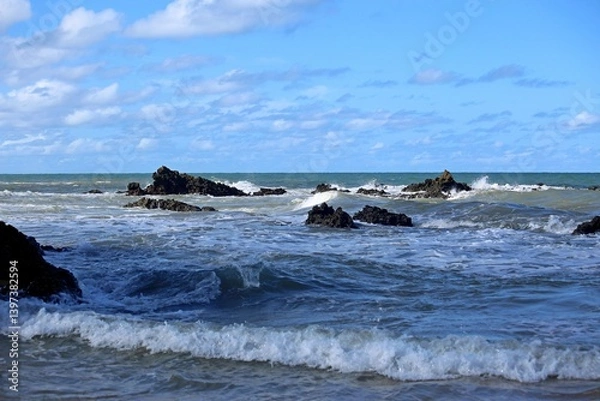 Obraz Blue sea with waves breaking near the sand of Coqueiros beach in the Joao Pessoa region, Northeast of Brazil. Sunny day with shadows and light over the water.