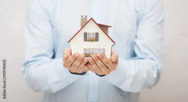 Fototapeta Small toy house in hands 