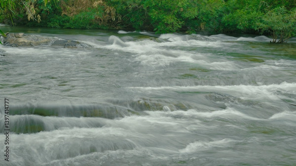 Fototapeta water flowing into the river