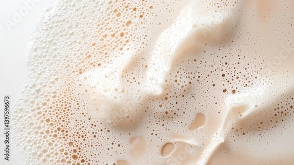 Fototapeta Close-up of frothy milk bubbles creating a textured pattern in creamy white tones.