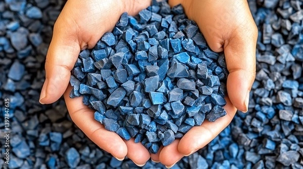 Obraz Hands holding a pile of recycled blue plastic chips.