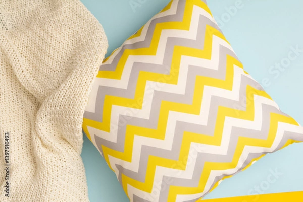 Fototapeta Pillow with zigzag pattern with textile plaid on blue background