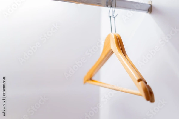 Obraz Clothes hangers are hanging on a rail in the wardrobe.