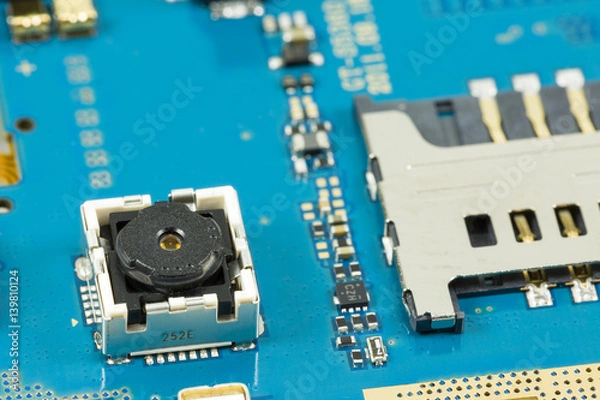 Fototapeta blue circuit board from smartphone with camera next to sim card slot