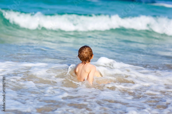Obraz little blond kid boy having fun on ocean beach in Florida