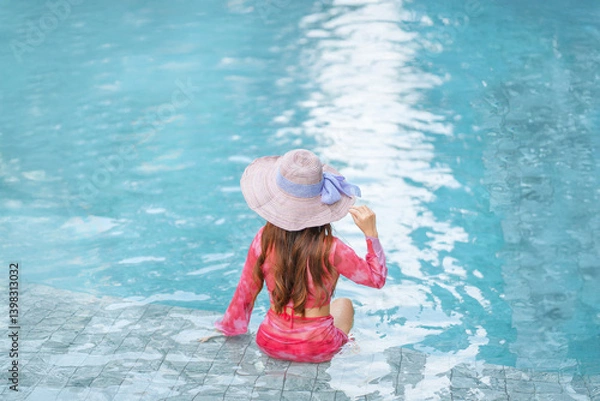 Obraz Beautiful Asain women with bikini enjoy summer vacation in the swimming pool.	