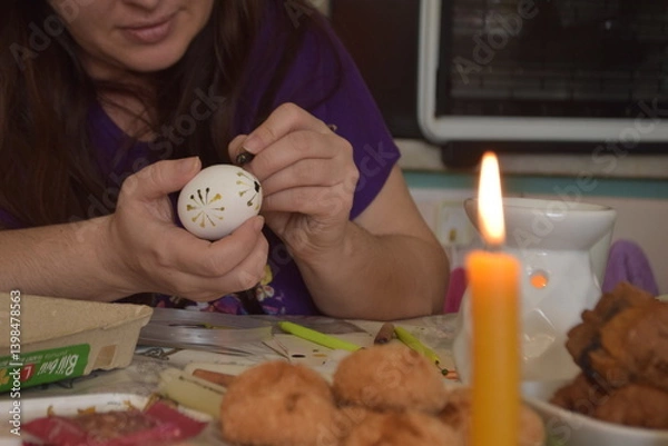 Obraz Hands that paint eggs with wax for Easter