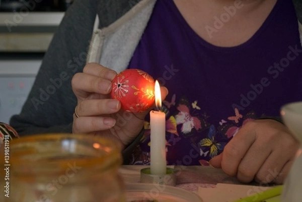 Obraz Hands that paint eggs with wax for Easter