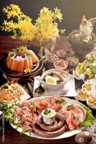 Obraz Easter breakfast with a plate of cold cuts, deviled eggs and vegetable salad on wooden table
