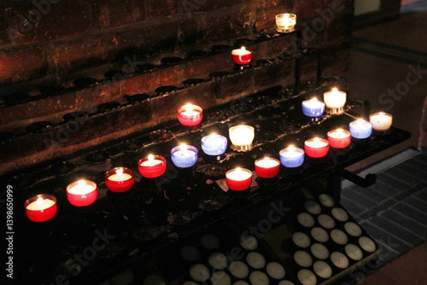 Fototapeta Remembrance Candles Lit on a Stand in a Church Chapel.