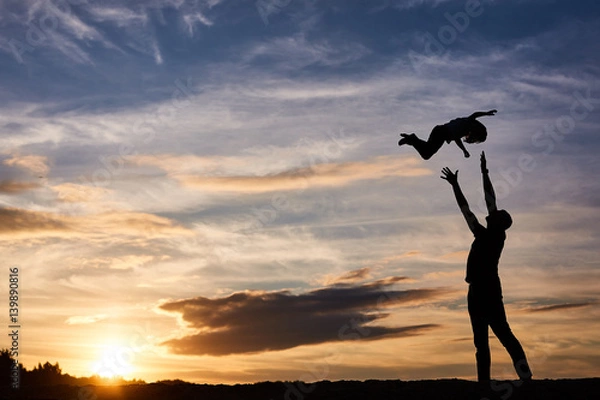 Obraz father and his daughter playing on the beach at the sunset time. Happy evening