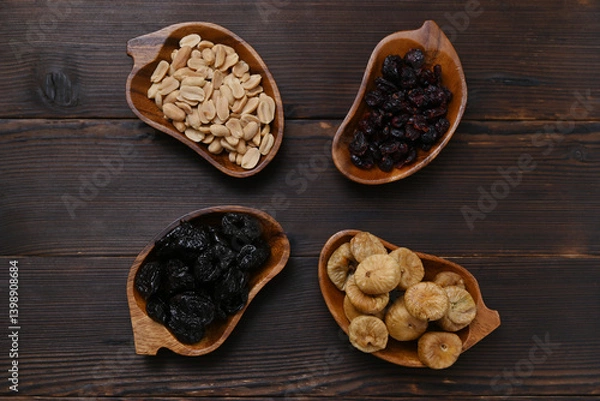 Obraz high-calorie snack, nuts and dried fruits in bowls on the table