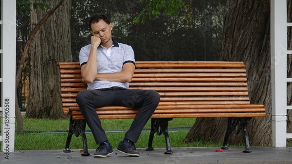 Fototapeta Sad Or Tired Man Alone On Bench