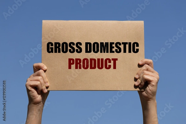 Fototapeta Gross domestic product text on brown paper holding by 2 hands of a man