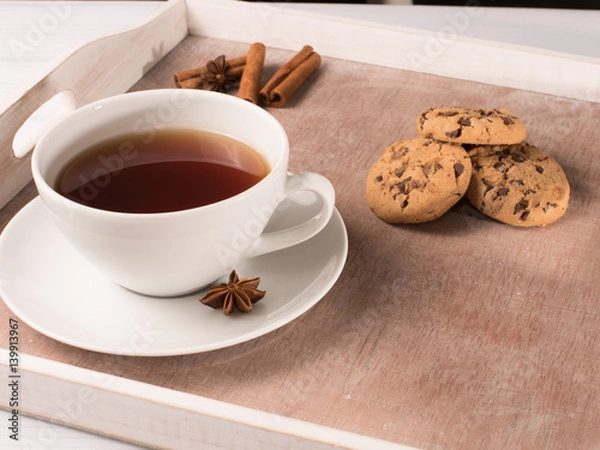 Fototapeta White cup of tea on the tray with cookie and chicory