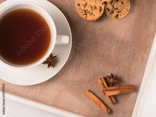 Fototapeta White cup of tea on the tray with cookie and chicory