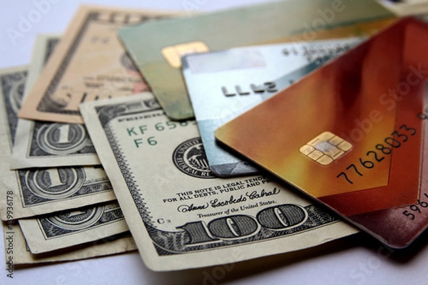 Fototapeta Stack of credit cards and american dollars, close-up view. Horizontal financial business background.