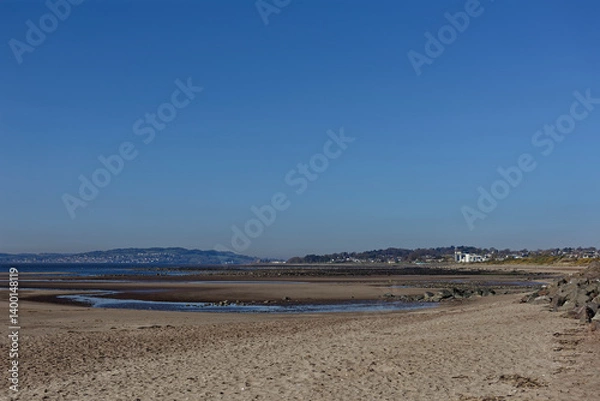 Obraz Monifieth Beach with the Tide out looking towards the Tay Estuary with Pools of water and rocks exposed on the foreshore.