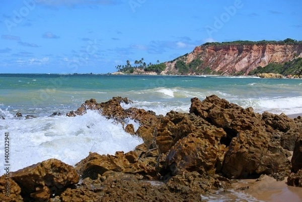 Obraz Tabatinga beach close to Joao Pessoa city, Paraiba state, Brazil northeast. Tropical seascape with waves crashing on rocks, blue sea, coloroful cliffs on horizon line. Toutistic place 