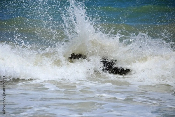 Obraz Strong water splitting on air, white foam by waves splashing on rock near the beach. Tabatinga beach, near Joao Pessoa city, Paraiba state, Brazil norheast