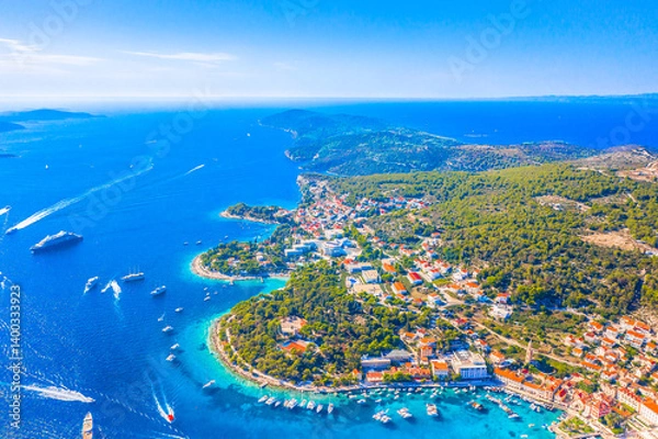 Fototapeta A stunning aerial view of the center of Hvar Town, Croatia, showcasing its vibrant marina filled with yachts, and Mediterranean charm that attracts visitors from around the world