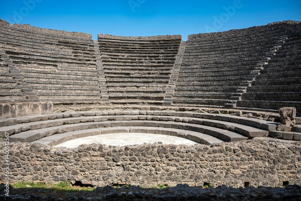 Fototapeta Ancient Roman Theatre of the ancient Roman city of Pompeii, buried by the eruption of Mount Vesuvius in 79 AD, with Mount Vesuvius visible in the distance, Italy