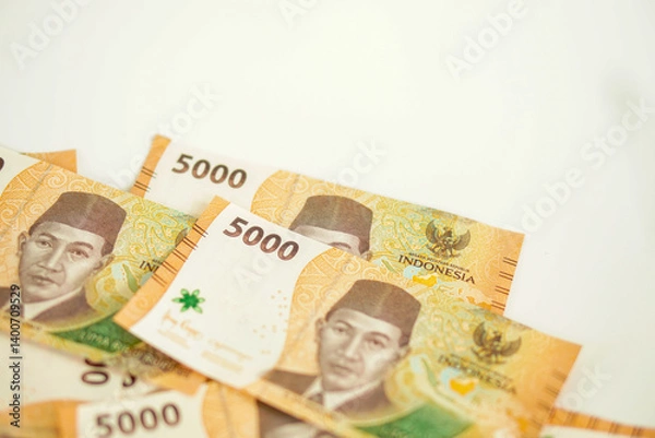 Fototapeta a stack of five thousand rupiah banknotes with negative space, which is Indonesia. suitable for background, finance, banking, cash, savings.