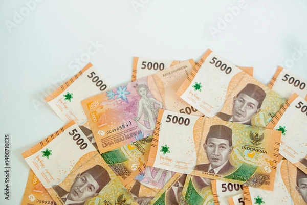 Fototapeta a stack of five thousand rupiah banknotes with negative space, which is Indonesia. suitable for background, finance, banking, cash, savings.