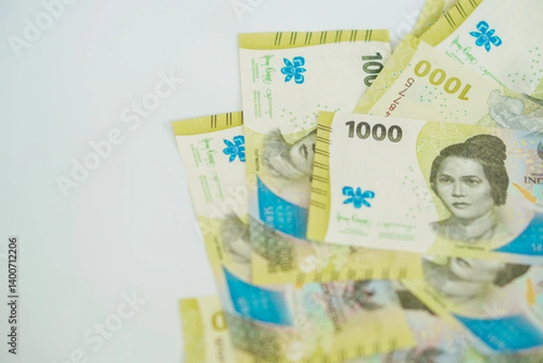 Fototapeta A stack of thousand rupiah banknotes with negative space, Indonesian money. suitable for background, finance, banking, cash, savings.