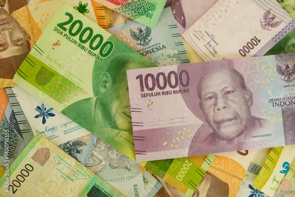 Fototapeta Various stacks of Indonesian banknotes, from one thousand rupiah to twenty thousand rupiah. Suitable for background, finance, banking, cash, savings.