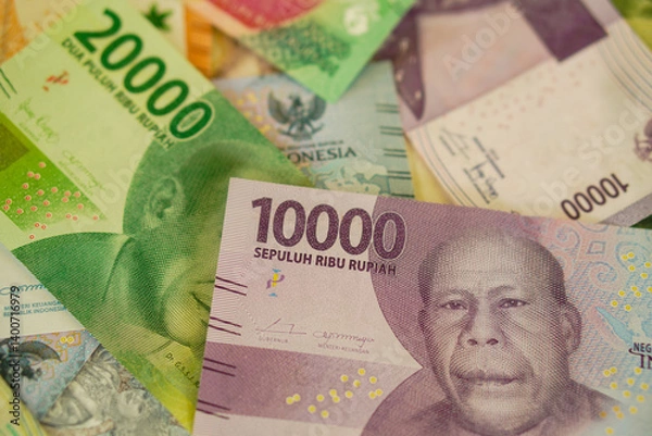 Fototapeta Various stacks of Indonesian banknotes, from one thousand rupiah to twenty thousand rupiah. Suitable for background, finance, banking, cash, savings.