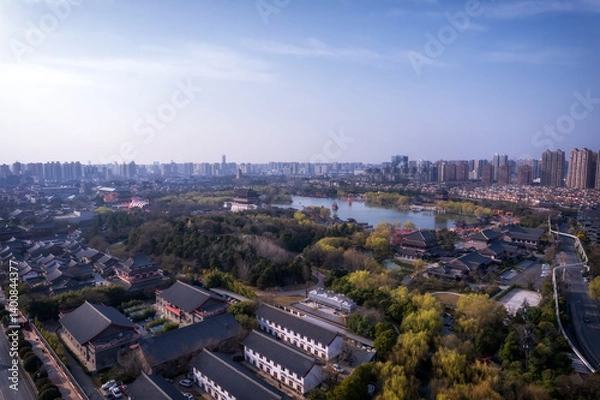 Fototapeta Aerial View of a Modern City Surrounded by Nature and Water