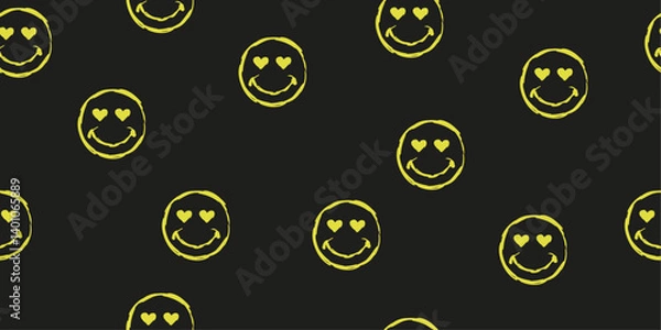 Fototapeta The image features a repeating pattern of yellow smiley faces with heart-shaped eyes on a black background.