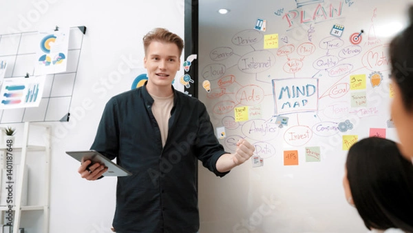 Obraz Professional male leader presents start up project by using mind map, colorful sticky notes and business statistic graph with confident while investor listening carefully. Immaculate.