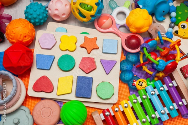 Obraz A pile of different children's toys scattered on a play mat.